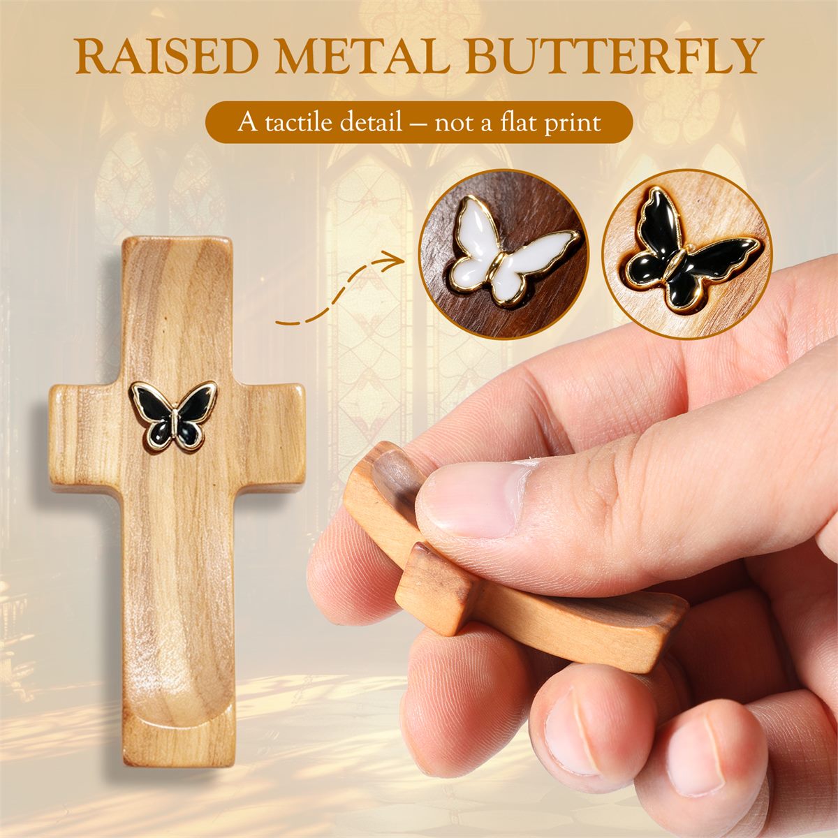 Close-up of the raised metal butterfly detail on a wooden pocket cross, held in hand